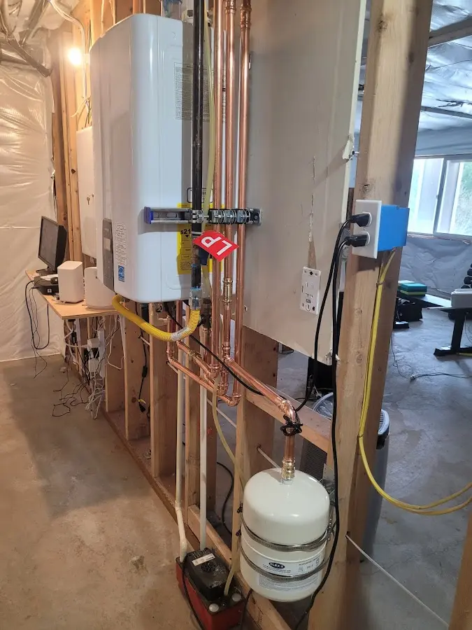 Licensed plumber repairing a kitchen sink in Adams